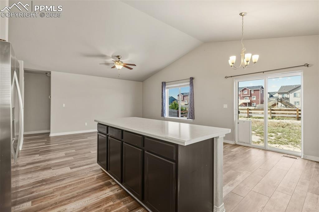 Image 8 of 27: Kitchen with pendant lighting, plenty of natural light, stainless steel fri