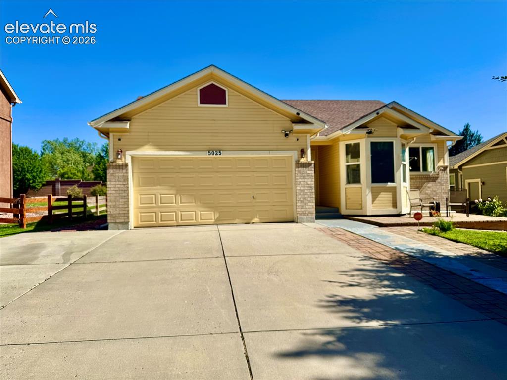 Image 1 of 39: Exterior featuring yellow siding, an attached two-car garage, and a bay win