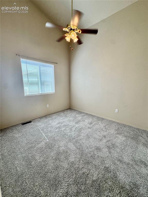 Image 18 of 39: Neutral-toned walls complement the gray textured carpeting