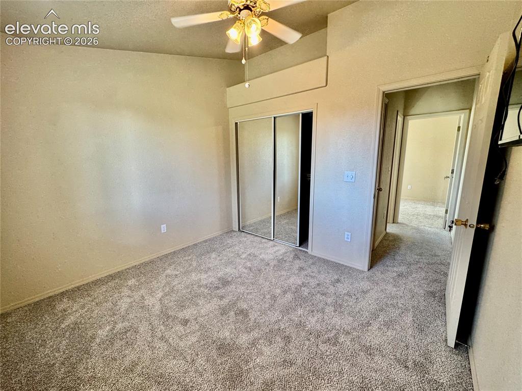 Image 19 of 39: Carpeted interior space featuring a ceiling fan with integrated lighting, m