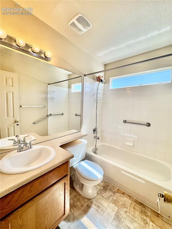 Image 20 of 39: Bathroom featuring a single vanity with an integrated sink, a full-width mi