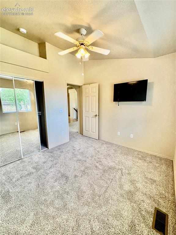 Image 21 of 39: Spacious room featuring light-toned carpeting, a ceiling fan with integrate