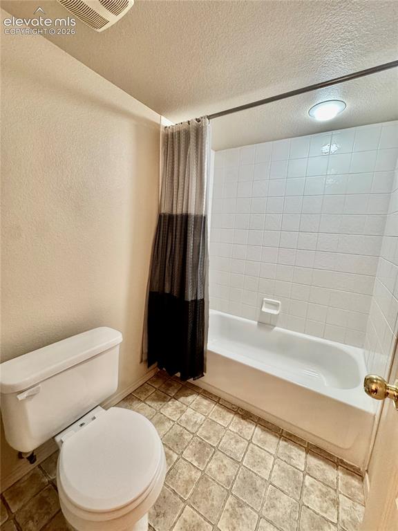 Image 24 of 39: Full-size bathtub with white subway tile surround and integrated soap dish