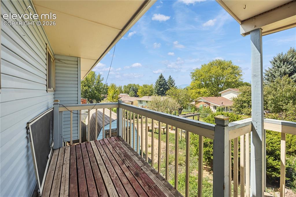 Image 31 of 35: Upper-level balcony featuring wood-finish flooring and painted railings