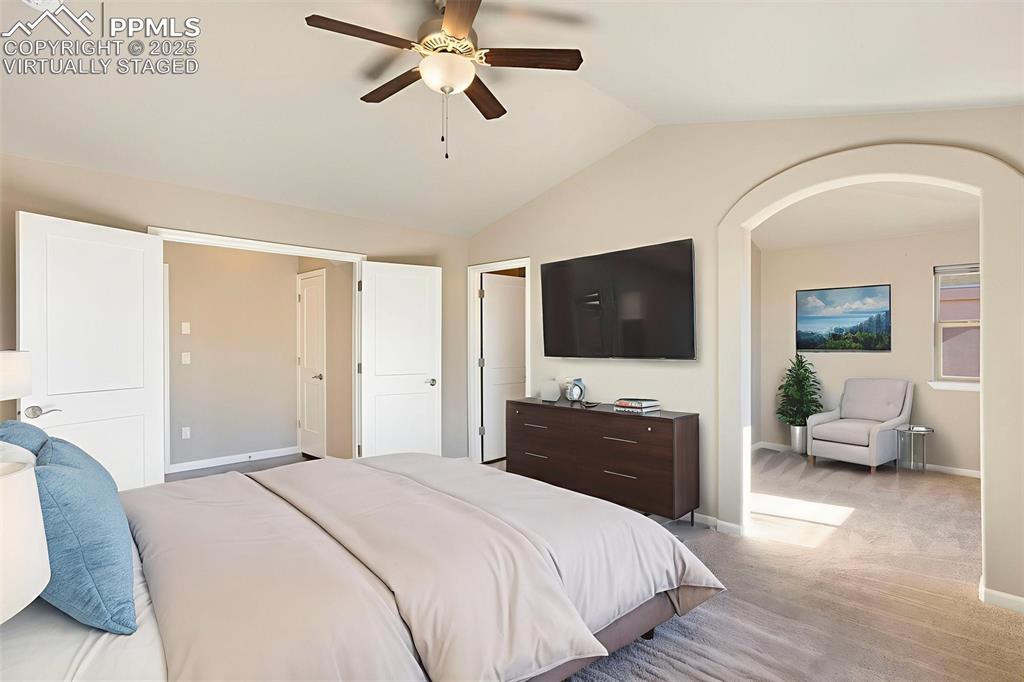 Image 18 of 48: Virtually Staged. Bedroom with vaulted ceiling, light colored carpet, a cei