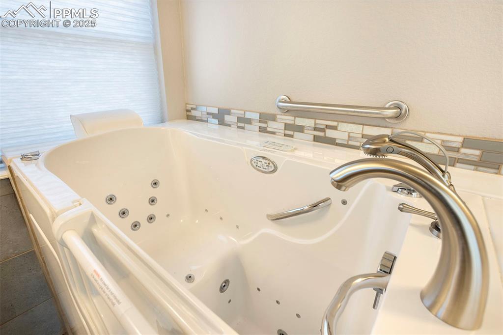 Image 26 of 48: Full bathroom featuring a jetted tub