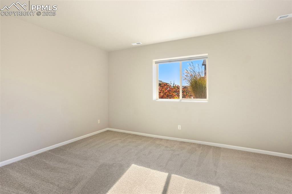 Image 27 of 48: Unfurnished room featuring carpet and baseboards