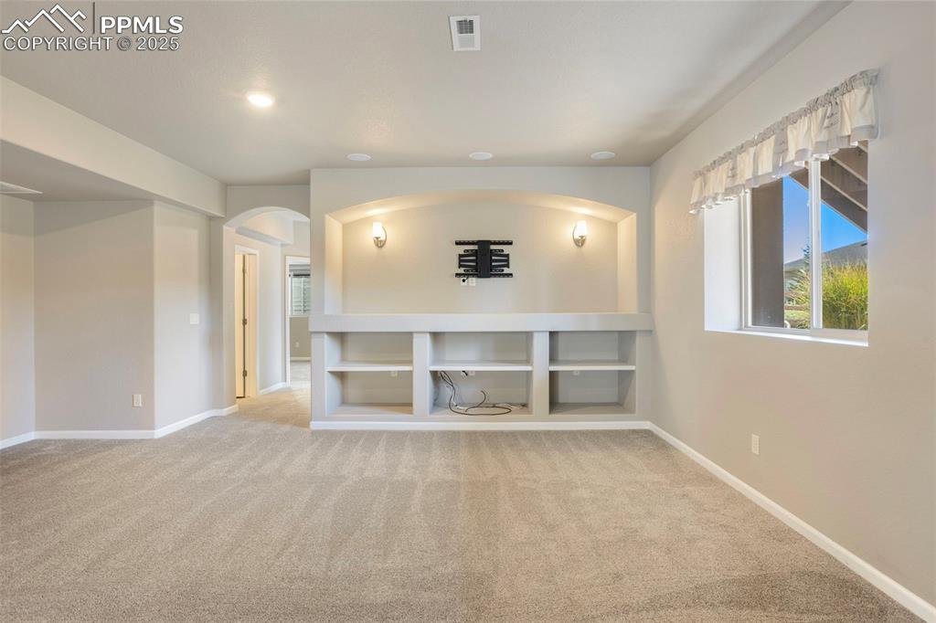 Image 34 of 48: Unfurnished room featuring light colored carpet, recessed lighting, and arc