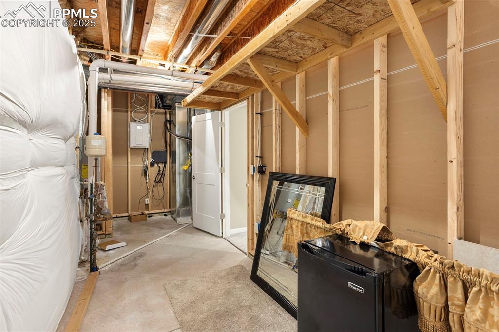 Image 42 of 48: Unfinished below grade area with black fridge