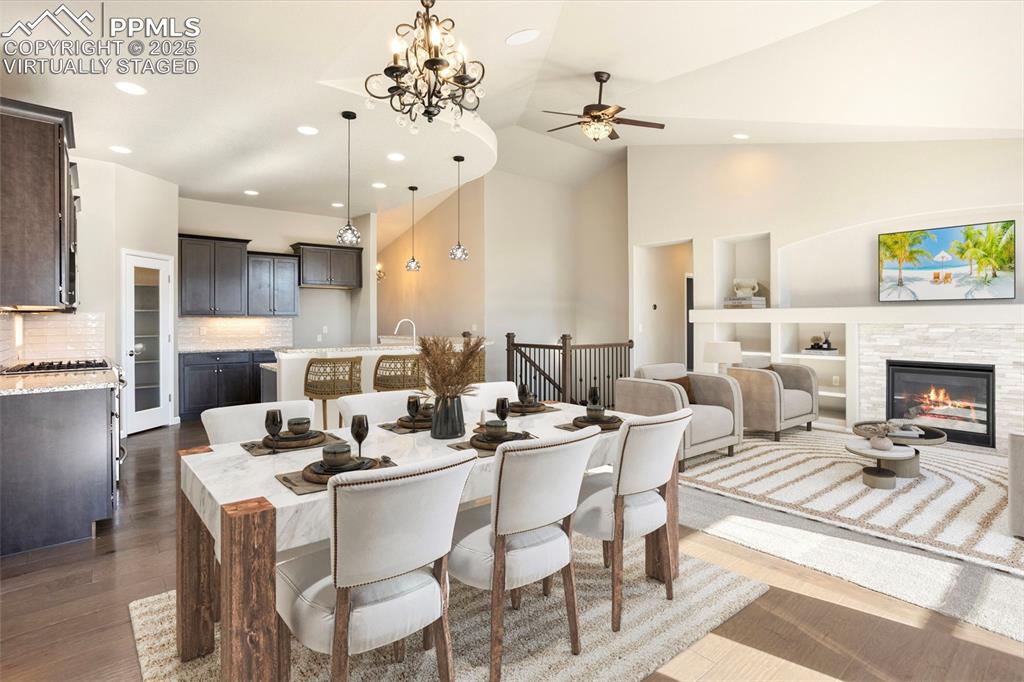 Image 7 of 48: Virtually Staged. Dining space featuring a chandelier, dark wood-type floor