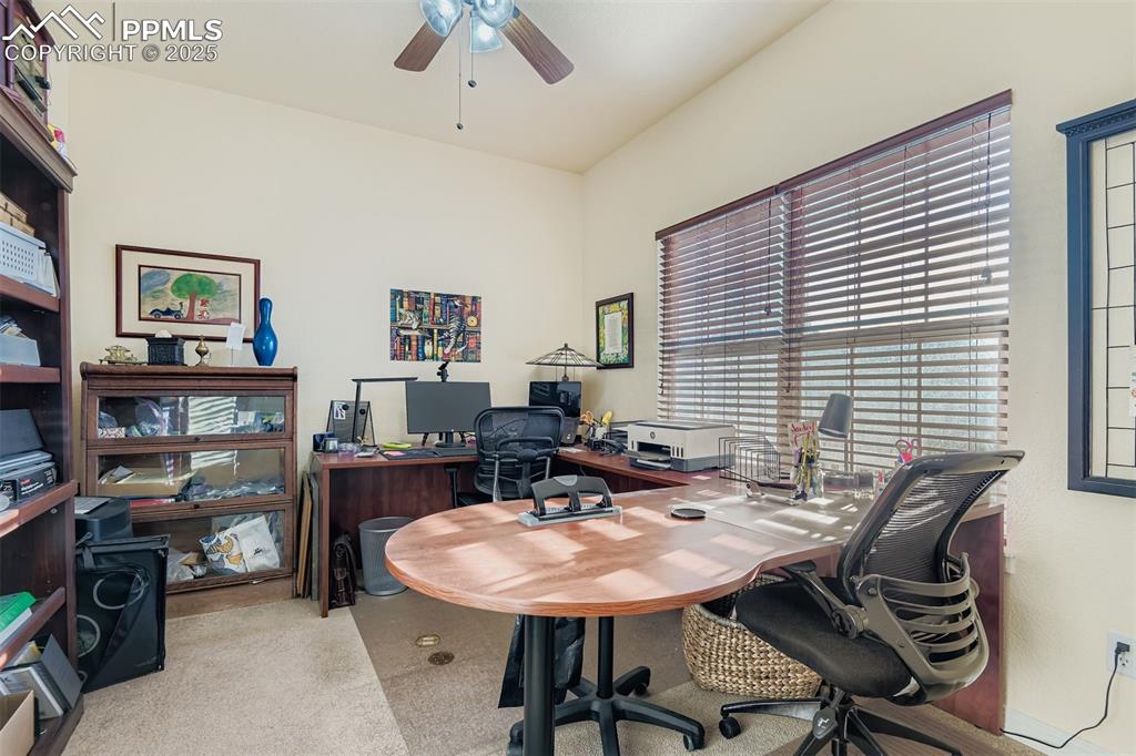 Image 10 of 29: Office featuring ceiling fan and light colored carpet