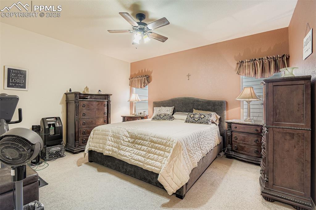 Image 16 of 29: Mater Bedroom featuring light colored carpet and ceiling fan