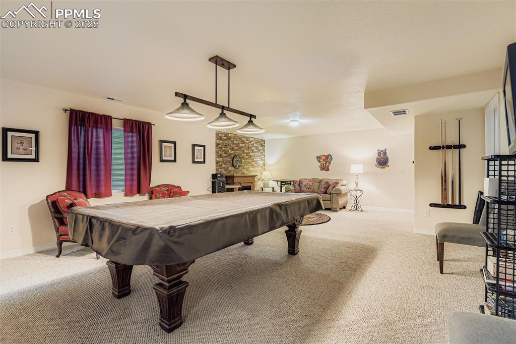 Image 21 of 29: Rec room with carpet flooring, billiards, and a electric  fireplace