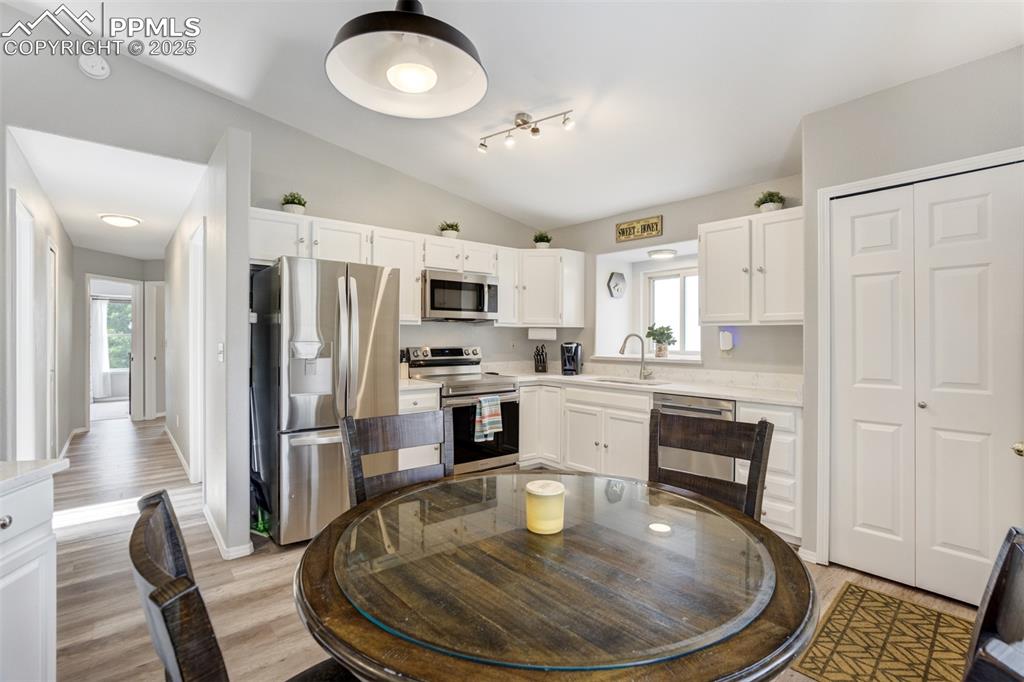 Image 12 of 36: Kitchen with stainless steel appliances, healthy amount of natural light, l