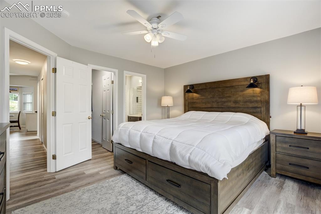 Image 16 of 36: Bedroom featuring light wood-style flooring, connected bathroom, and a ceil