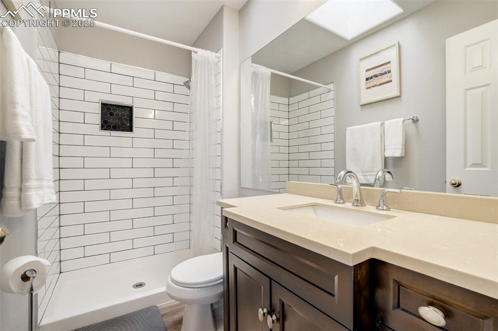 Image 18 of 36: Full bath featuring vanity and a tile shower