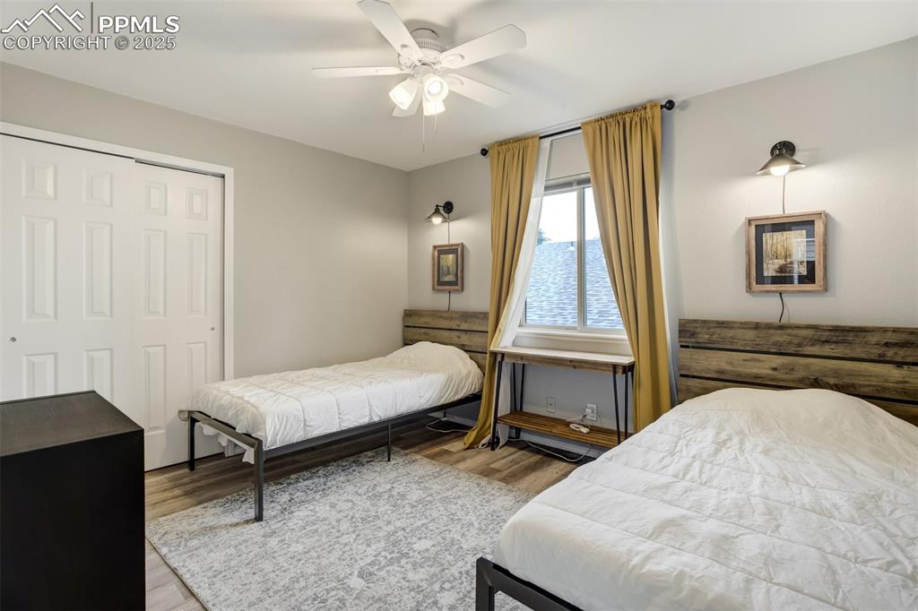 Image 19 of 36: Bedroom featuring a closet, wood finished floors, and ceiling fan