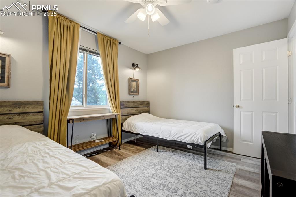 Image 20 of 36: Bedroom featuring wood finished floors and a ceiling fan