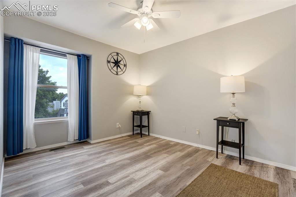 Image 21 of 36: Empty room featuring a ceiling fan and light wood finished floors