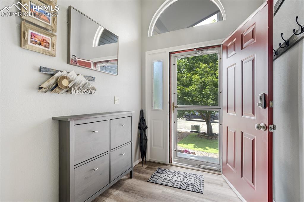 Image 3 of 36: Entryway with light wood-style floors