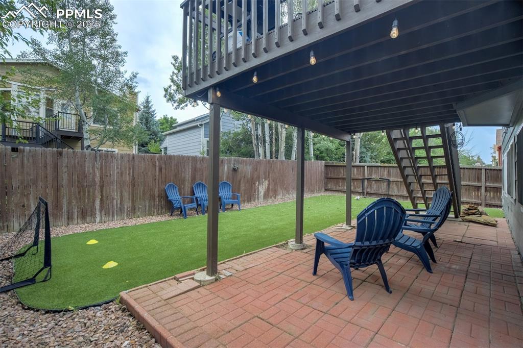 Image 32 of 36: Fenced backyard featuring a patio area