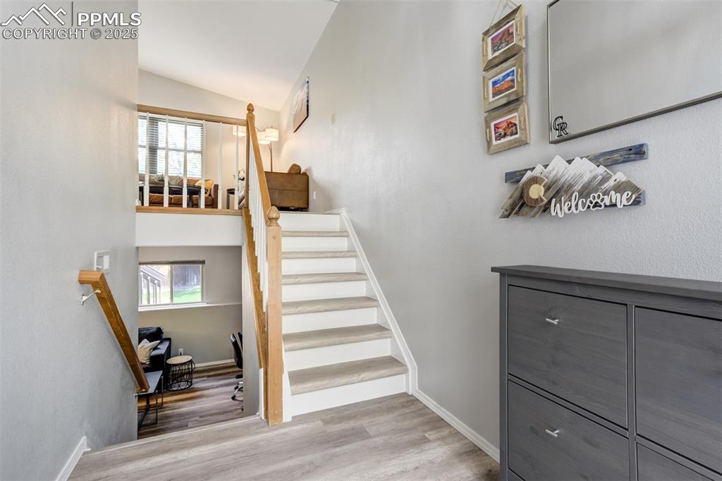 Image 4 of 36: Staircase with wood finished floors and lofted ceiling
