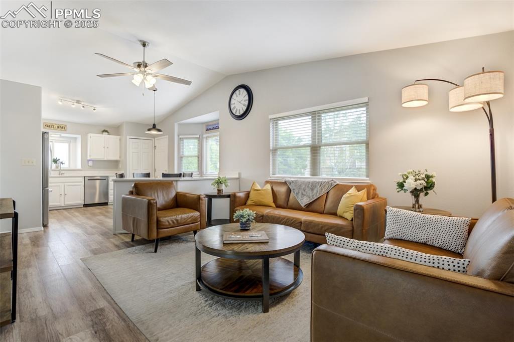 Image 5 of 36: Living room with light wood-style floors, ceiling fan, and lofted ceiling