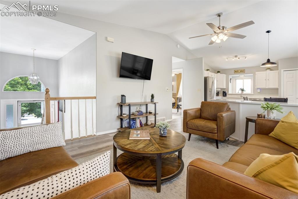 Image 6 of 36: Living area featuring lofted ceiling, light wood-type flooring, and a ceili