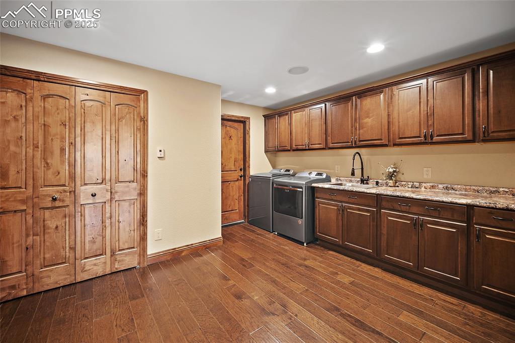 Image 37 of 47:  washer and dryer, dark wood-type flooring, recessed lighting, and light st