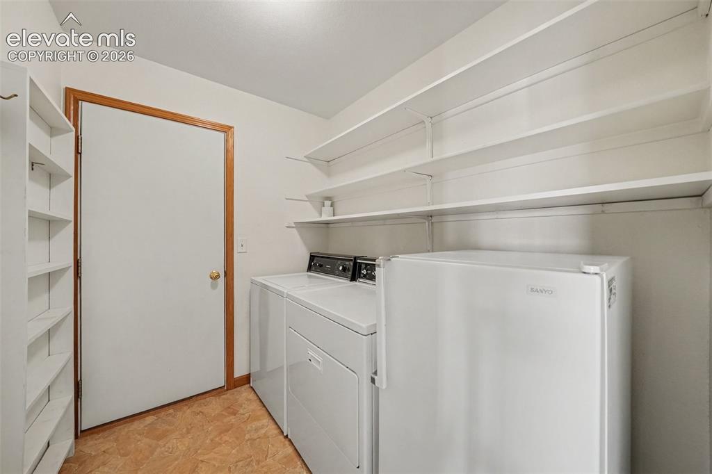 Image 14 of 33: Main Level Laundry.  Washer, Dryer, Freezer