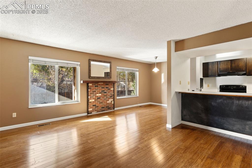 Image 4 of 20: Unit 125 with hardwood floors and new vinyl windows