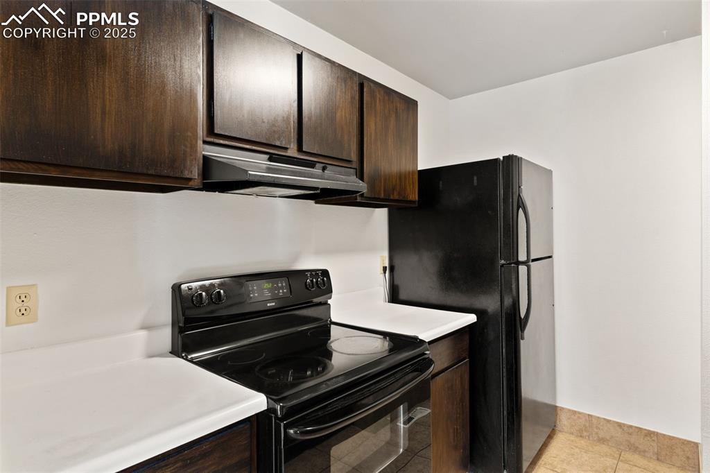 Image 6 of 20: Black kitchen appliances, including range/oven, refrigerator, and dishwashe