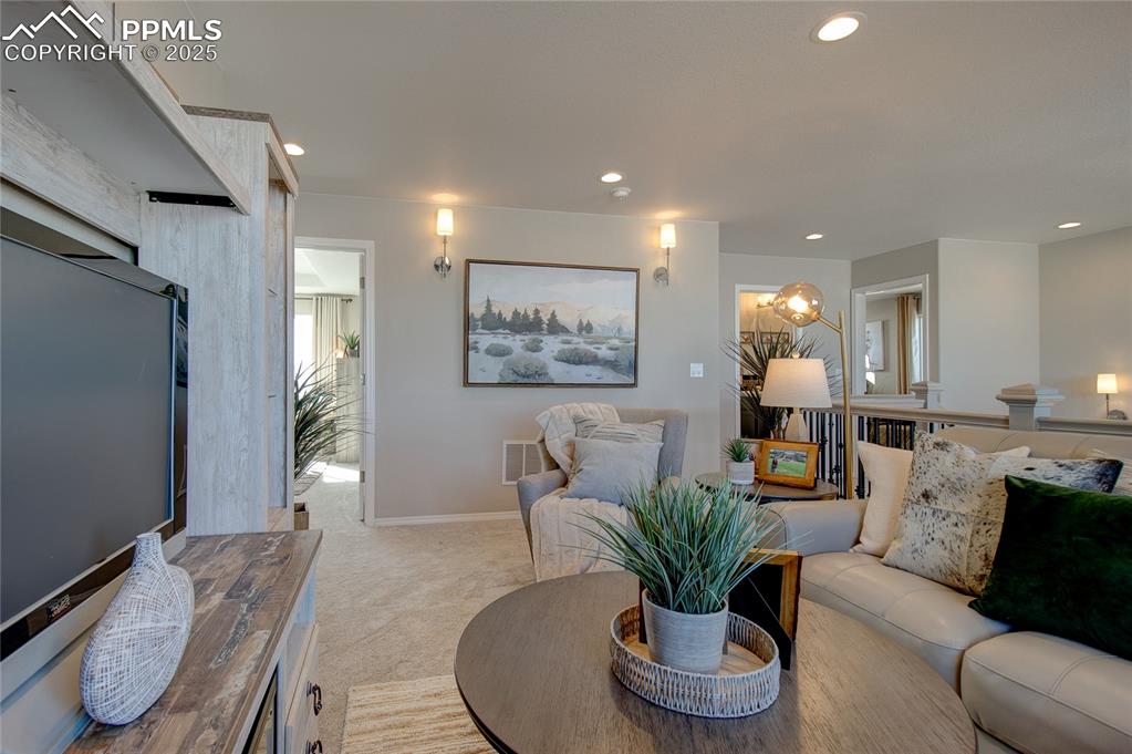 Image 10 of 32: Living room featuring recessed lighting and light colored carpet