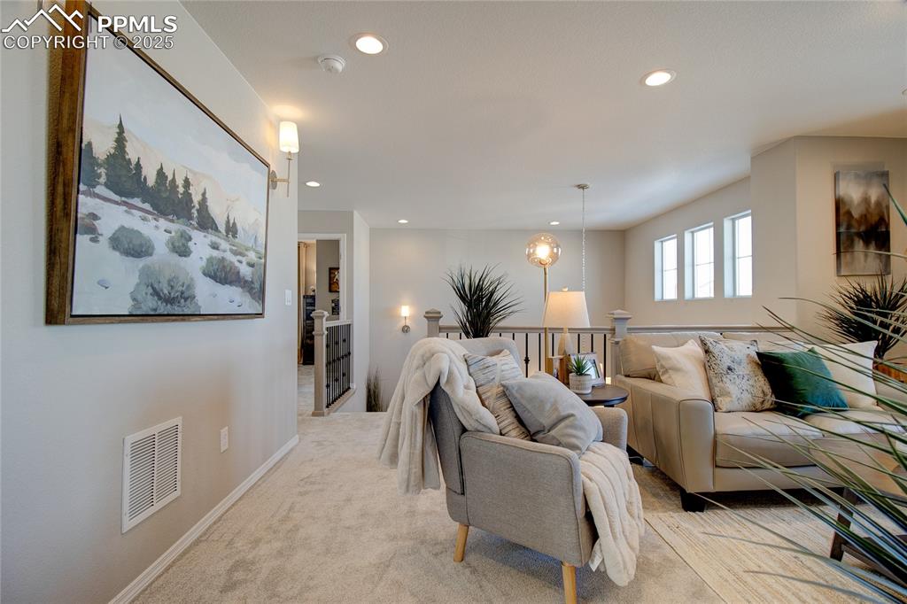 Image 11 of 32: Living area featuring recessed lighting and light carpet