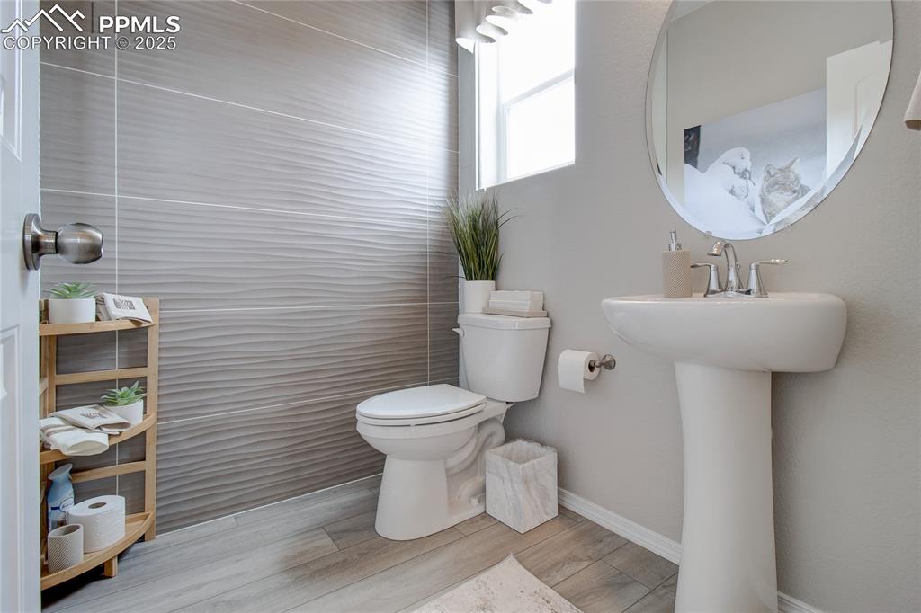 Image 17 of 32: Half bathroom featuring toilet and wood finished floors