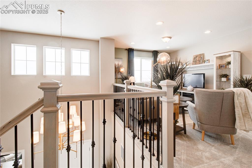 Image 18 of 32: Staircase with carpet flooring and recessed lighting