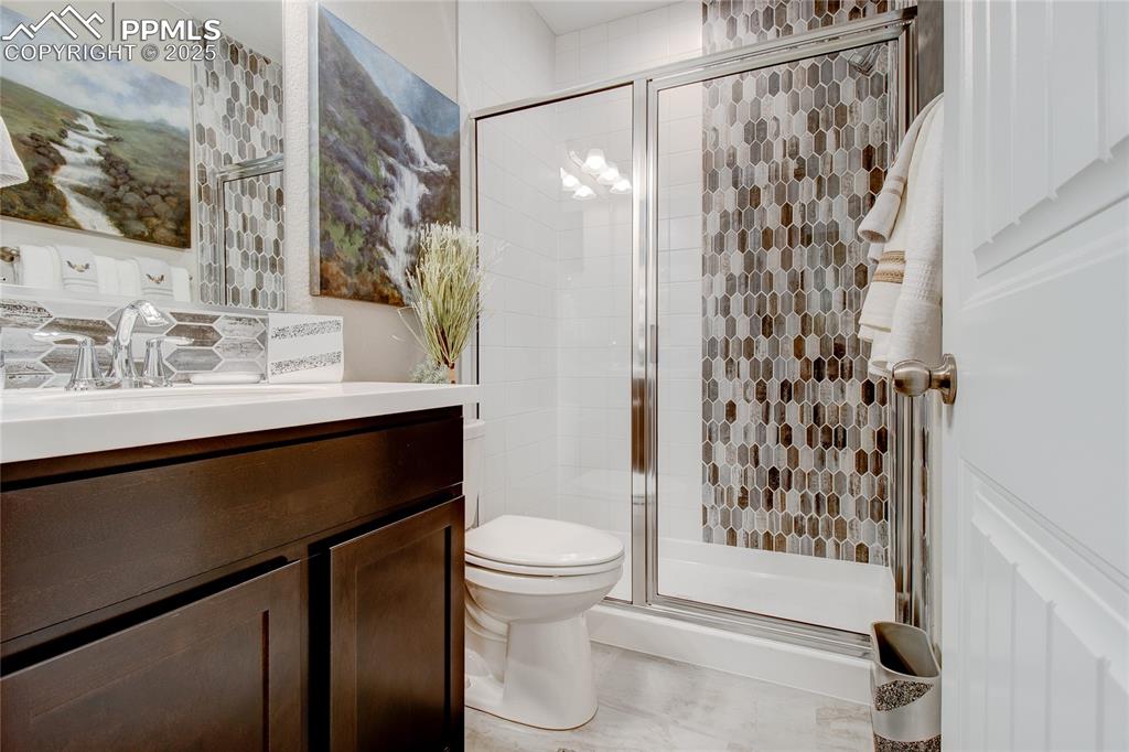 Image 30 of 32: Bathroom featuring vanity and a shower stall