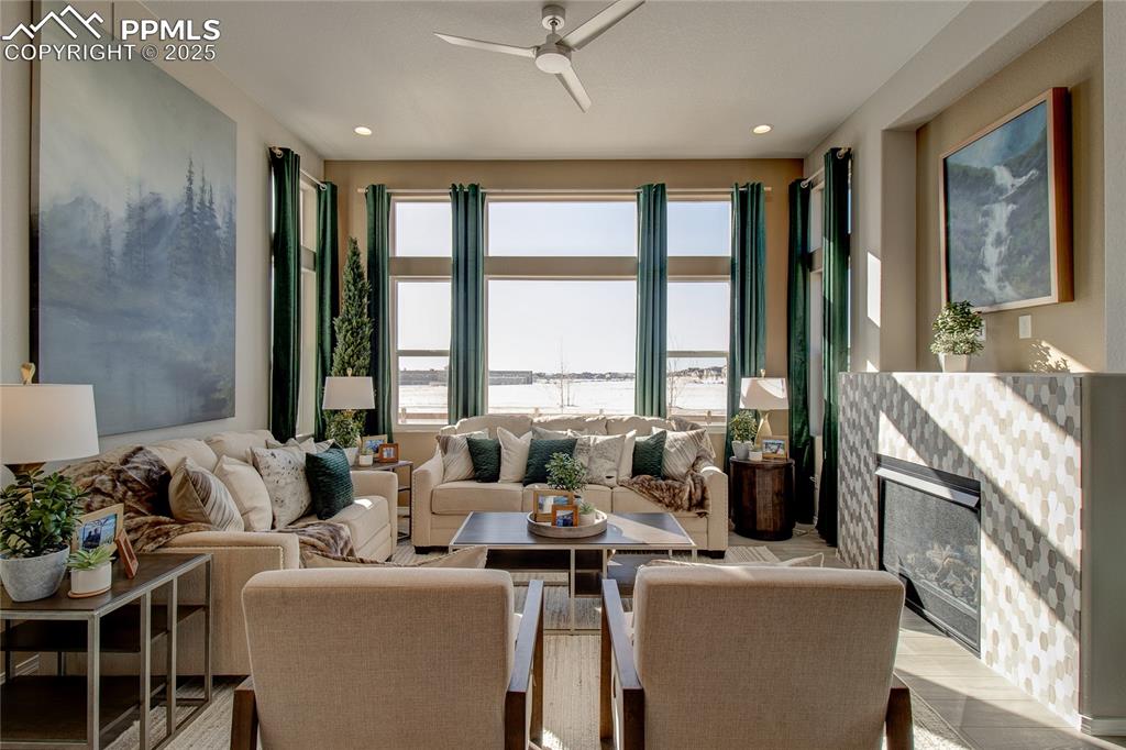 Image 6 of 32: Living area featuring a ceiling fan and recessed lighting