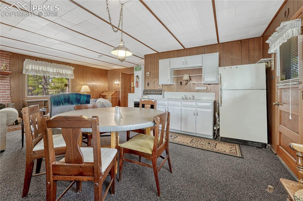 Image 3 of 41: Kitchen area with electric stove, refrigerator and sink