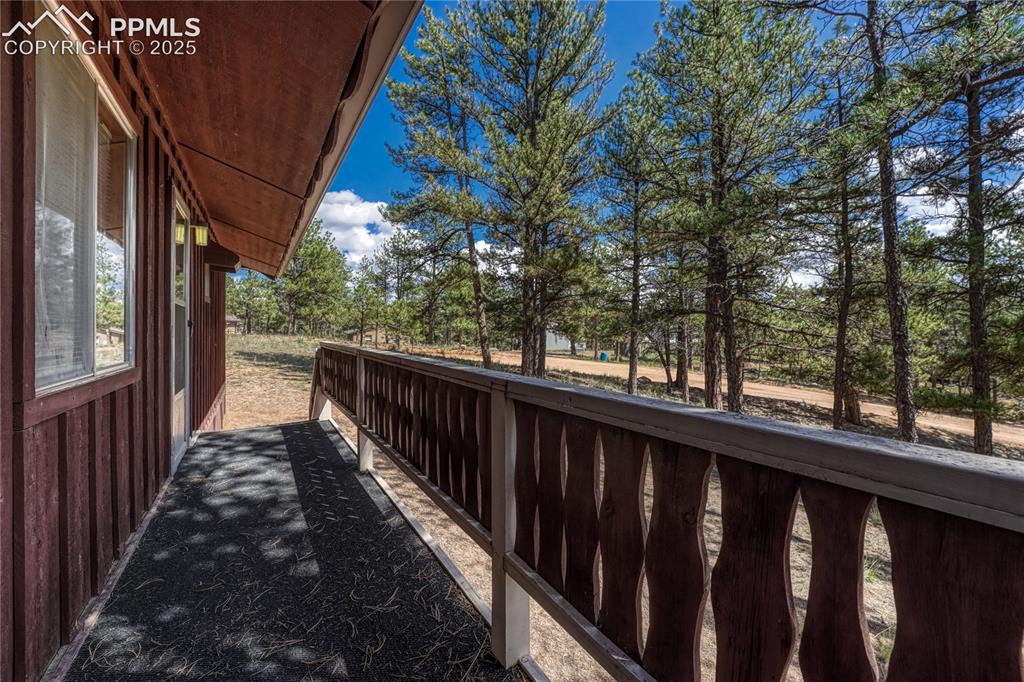 Image 7 of 41: Front porch with outdoor carpeting running the length of the house
