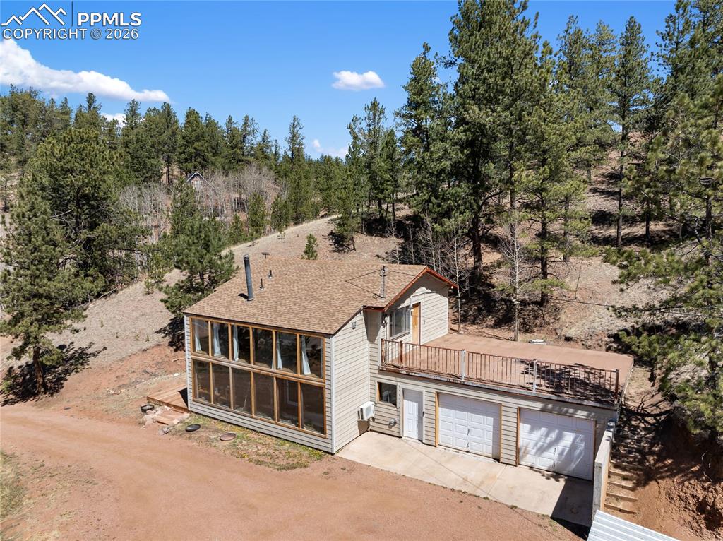 Image 35 of 46: Garden sunroom and wood burning fireplace