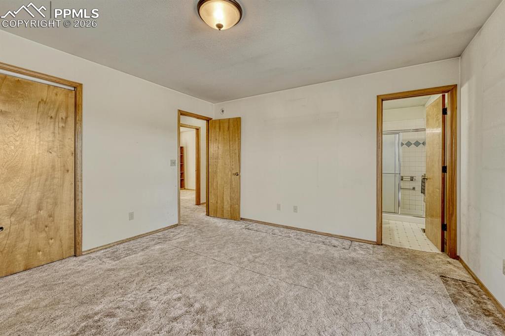Image 30 of 50: (Main Level) Primary bedroom with en-suite bath.