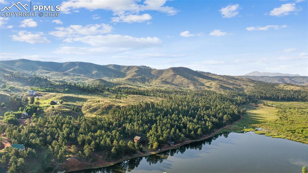 Image 16 of 26: View of mountain back ground featuring a nearby body of water