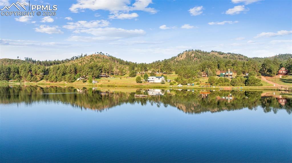 Image 4 of 26: Water view with a forest and a mountain backdrop
