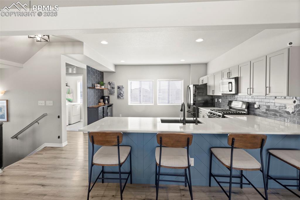 Image 4 of 50: Kitchen Peninsula was updated with custom design.