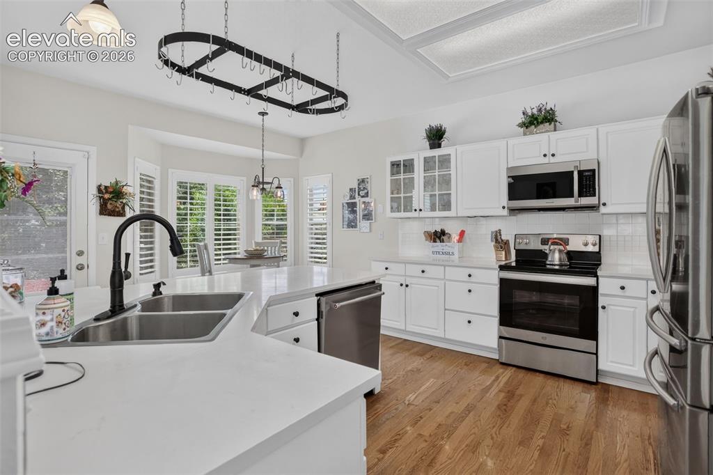 Image 17 of 49: Kitchen featuring a large island with an undermount double sink, a black go