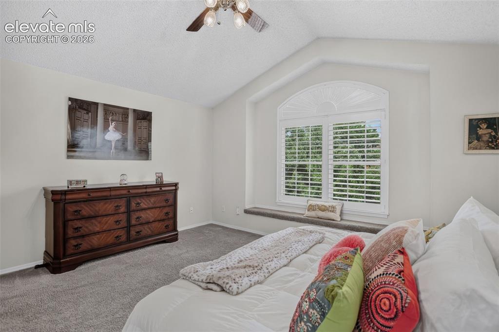 Image 25 of 49: Vaulted ceiling with a ceiling fan light fixture