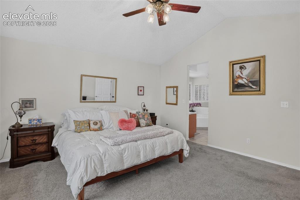 Image 26 of 49: Spacious room featuring vaulted ceilings, light neutral wall tones, and gra