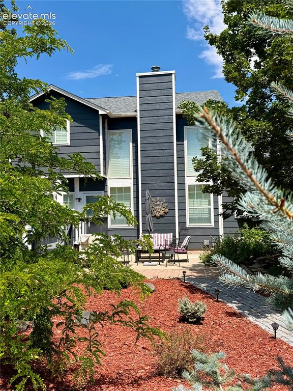 Image 33 of 49: Outdoor patio featuring a stone water feature, a paved brick section, and a