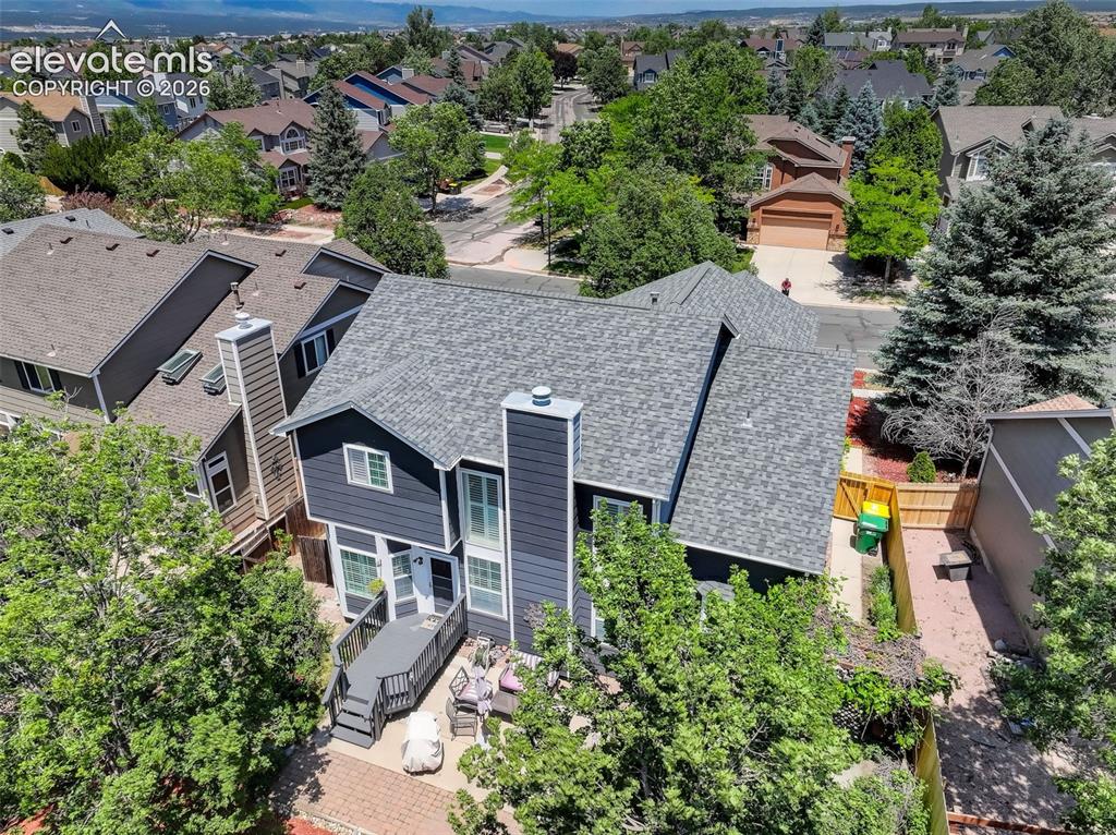 Image 35 of 47: Two-story residence featuring a dark blue exterior with white trim, a multi